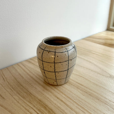 Small ceramic vase with grid pattern on a wooden surface. Mae Ceramics | Shop Fodder