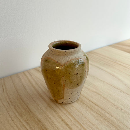 Ceramic vase on a wooden surface with a white background.  Mae Ceramics | Shop Fodder