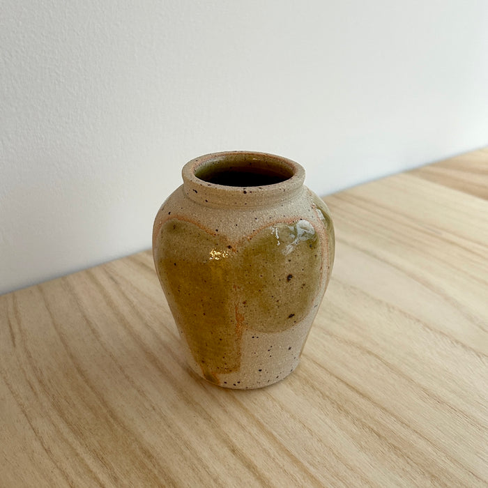 Ceramic vase on a wooden surface with a white background.  Mae Ceramics | Shop Fodder