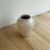 Small ceramic vase with speckled texture on a wooden surface. Mae Ceramics | Shop Fodder