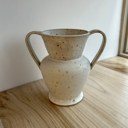 Speckled ceramic vase with handles on a wooden surface. Mae Ceramics | Shop Fodder