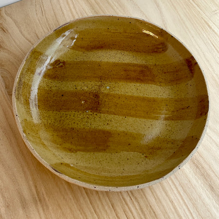 Round ceramic object with a textured surface on a wooden surface. Mae Ceramics | Shop Fodder