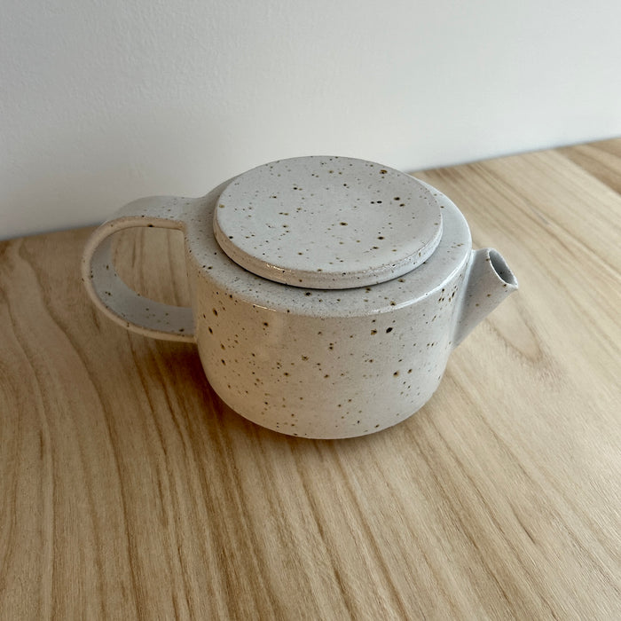 Speckled ceramic teapot on a wooden surface. Mae Ceramics | Shop Fodder