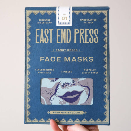 Hand holding a box of East End Press face masks against a light background. Masks | East End Press | Shop Fodder