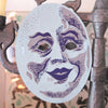Decorative mask with purple accents on a decorative stand. Masks | East End Press | Shop Fodder