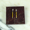 Pair of earrings on a maroon card with a marble background  | Scarlett Cohen French | Shop Fodder