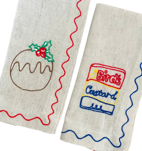 Two embroidered fabric items with a Christmas pudding and Birds Custard design on a white background. See & Quin | Embroidered Linen Napkins | Shop Fodder
