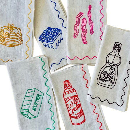 Set of fabric napkins with colorful illustrations on a white background. See & Quid | Shop Fodder