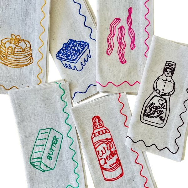 Set of fabric napkins with colorful illustrations on a white background. See & Quid | Shop Fodder