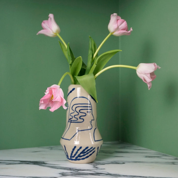 a hand painted ceramic vase by sophie alda. with pink tulips on a green background. 