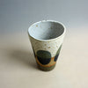 Speckled ceramic cup with abstract design on a neutral background. Sophie Alda | Shop Fodder