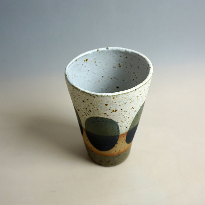 Speckled ceramic cup with abstract design on a neutral background. Sophie Alda | Shop Fodder