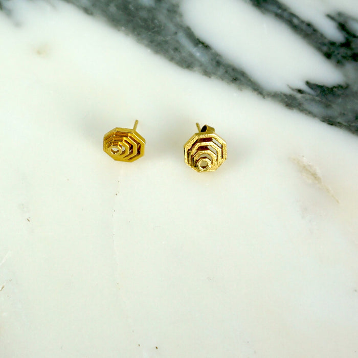 Gold geometric stud earrings on a marble surface | Mini Nudge Studs in Sterling Silver | Scarlett French | Shop Fodder