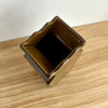 Bronze-colored square container on a wooden surface. Studio ERS | Ceramic Vase | Shop Fodder