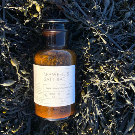 Bottle of Seaweed & Salt Bath on a bed of seaweed | Handmade Seaweed Bath Salts | WASI Seaweed | Shop Fodder
