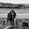 Two people standing in a field with a dog, black and white photo | Infused Seaweed Body Oil | WASI Seaweed | Shop Fodder
