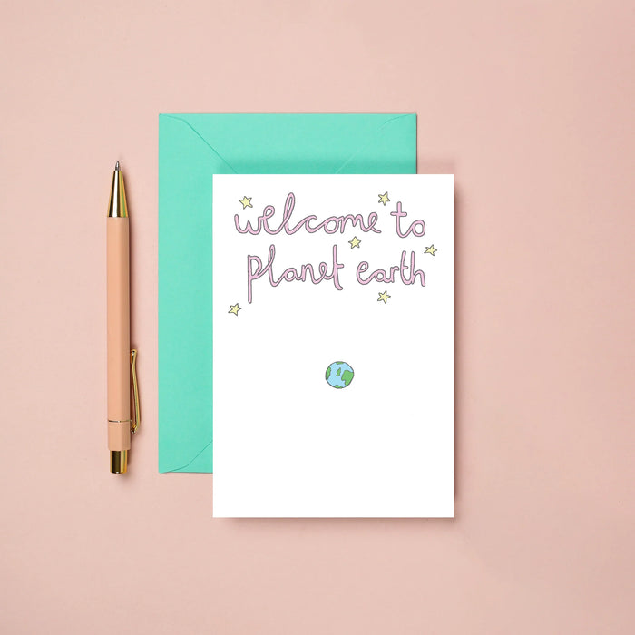 greetings card with a drawing of the earth and it reads "welcome to planet earth" 