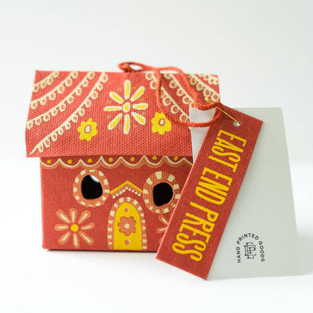 Red house-shaped product with yellow details and 'East End Press' tag on a white background. East End Press | Shop Fodder