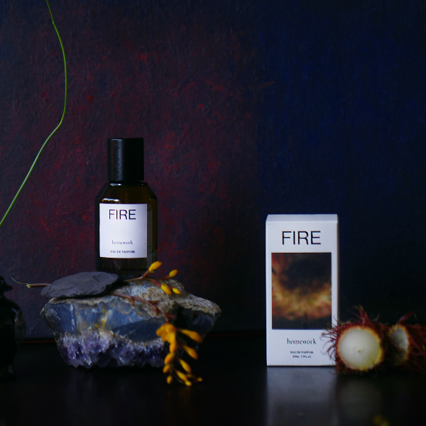 Bottle and box of 'FIRE' product with decorative elements on a dark background | Homework Store | Shop Fodder