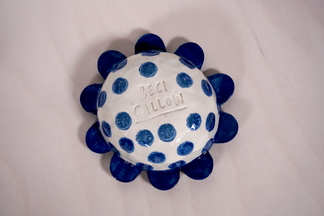 the base of a flower dish with the makers mark of ceramicist beci callow. 
