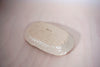 the base of a clay coloured soap dish, with the maker mark of Beci Callow Ceramicist. 