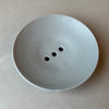 a duck egg blue ceramic soap dish with three drainage holes. 