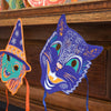Colorful paper masks on a wooden surface with a blurred background. Masks | East End Press | Shop Fodder