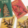 Collection of East End Press wooden ornaments on cards with Christmas-themed designs.  | East End Press | Shop Fodder