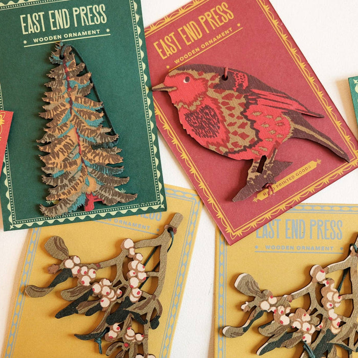 Collection of East End Press wooden ornaments on cards with Christmas-themed designs.  | East End Press | Shop Fodder
