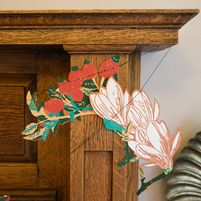 Decorative floral wall art hanging on a wooden wall. East End Press | Shop Fodder