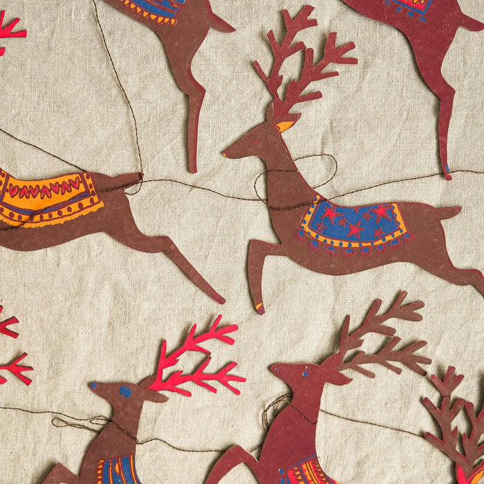 Pattern of stylized deer with colorful antlers on a textured beige background. | East End Press | Shop Fodder