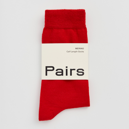 Red merino sock with 'Pairs' branding on a white background.  Pairs Socks | Shop Fodder