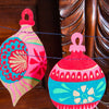 Decorative Christmas ornaments hanging on a wooden surface | East End Press | Shop Fodder