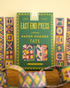 Packaging of East End Press paper chains with colorful geometric patterns on a wooden surface.