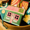 Colorful paper houses in a wooden bowl on a wooden surface. East End Press | Shop Fodder