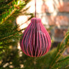 Pink woven ornament hanging on a Christmas tree branch | East End Press | Shop Fodder