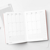 Open planner on a desk with a cup of coffee, pencils, and a notebook. 2026 Planner | Kinshipped | Shop Fodder