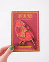 Robin wooden ornament with bird design held by a hand against a white background | East End Press | Shop Fodder