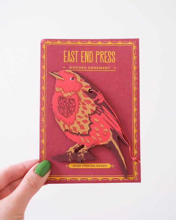 Robin wooden ornament with bird design held by a hand against a white background | East End Press | Shop Fodder